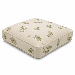 Ivory square floor cushion with olive botanical sprig print on white background
