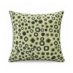 Primeval olive green and sage leopard spot cushion cover with irregular animal-inspired markings over beige