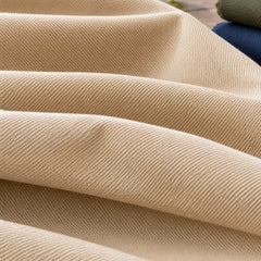 Beige cotton drill fabric with characteristic diagonal twill surface and folded shade references; Primeval fabric sourcing reference PML-FAB-012