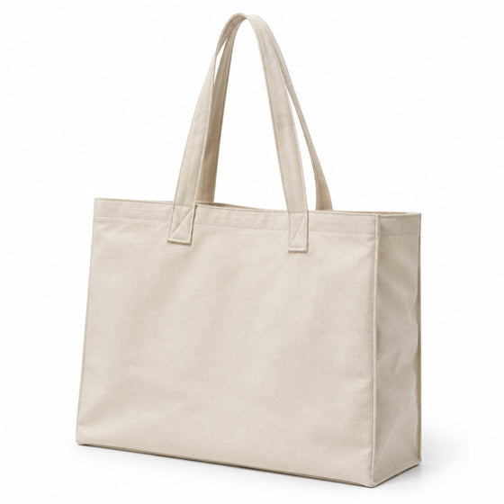 Premium natural canvas tote bag with clean classic styling, wide gusset and long handles on a white background.