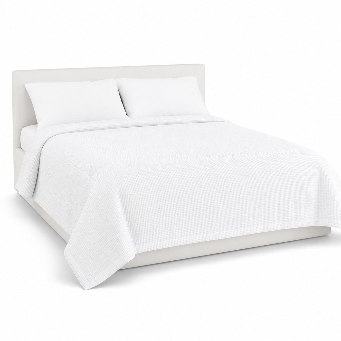 Primeval pure white waffle texture duvet cover displayed on a styled bed against a clean white studio background