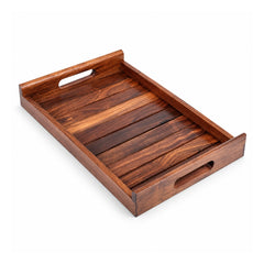 Deep dark-brown rectangular wooden serving tray with raised straight sides, narrow wood slats across the base and cutout handgrips at both ends