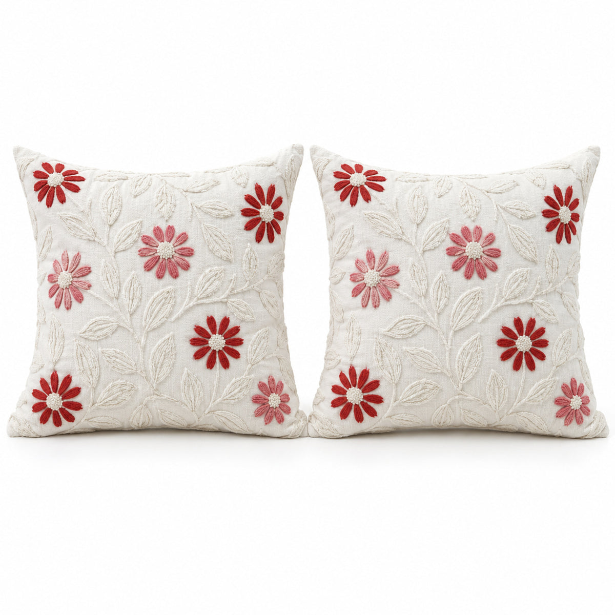 Pair of ivory decorative cushions with red and pink daisy floral motifs