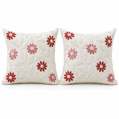 Pair of ivory decorative cushions with red and pink daisy floral motifs