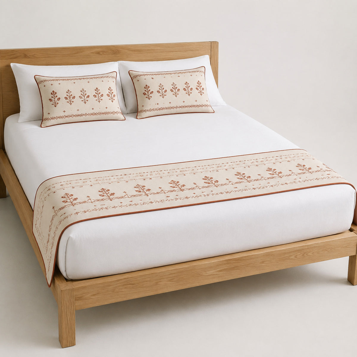 Soft rose floral border bed runner styled on white bedding for wholesale boutique, hospitality and private-label bedroom sourcing