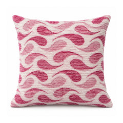 Primeval decorative throw cushion with rose pink wavy scallop pattern on a cream background, shown against a white background