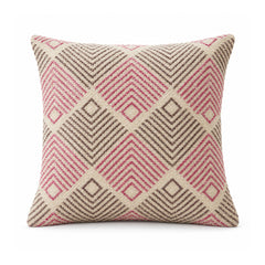 Primeval dusty rose pink and olive grey cushion cover with chevron-filled diamond shapes in a repeating geometric arrangement