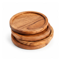 Stacked round wooden coasters with recessed centers, raised circular rims and golden-brown natural-looking grain