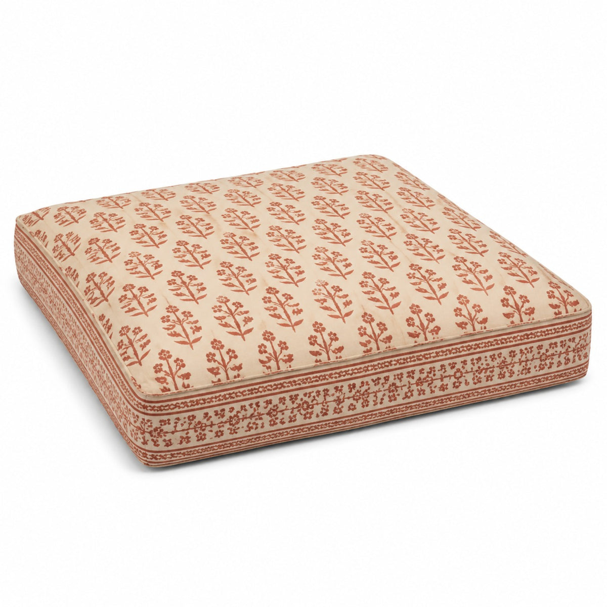 Ivory square floor cushion with rust all-over floral motif and decorative border on white background