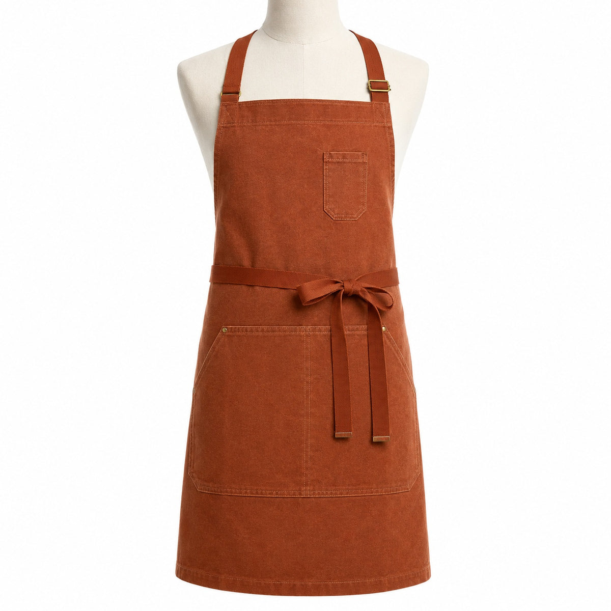 Primeval rust tone cross-back chef apron with front pocket displayed on a dress form