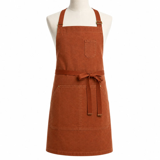 Primeval rust tone cross-back chef apron with front pocket displayed on a dress form