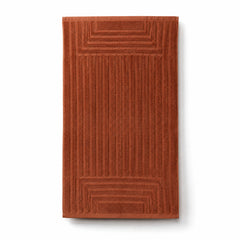 Rust orange sculpted linear cotton terry bath towel 70x140 cm for architectural hotel and spa linen
