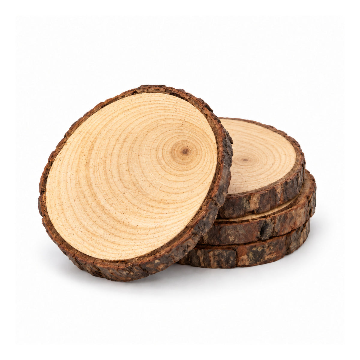 Four round wood-slice coasters with pale tree rings and rugged bark edges, three stacked with one displayed upright