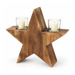 Freestanding rustic brown wooden five-point star with two clear-glass tealight cups and white candles on its upper arms