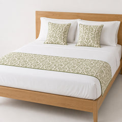 Sage all-over botanical bed runner styled on white bedding for wholesale resort, boutique hotel and private-label sourcing