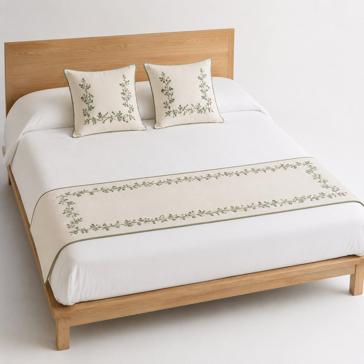 Sage botanical border bed runner styled on white bedding for wholesale boutique hotel, resort and private-label sourcing