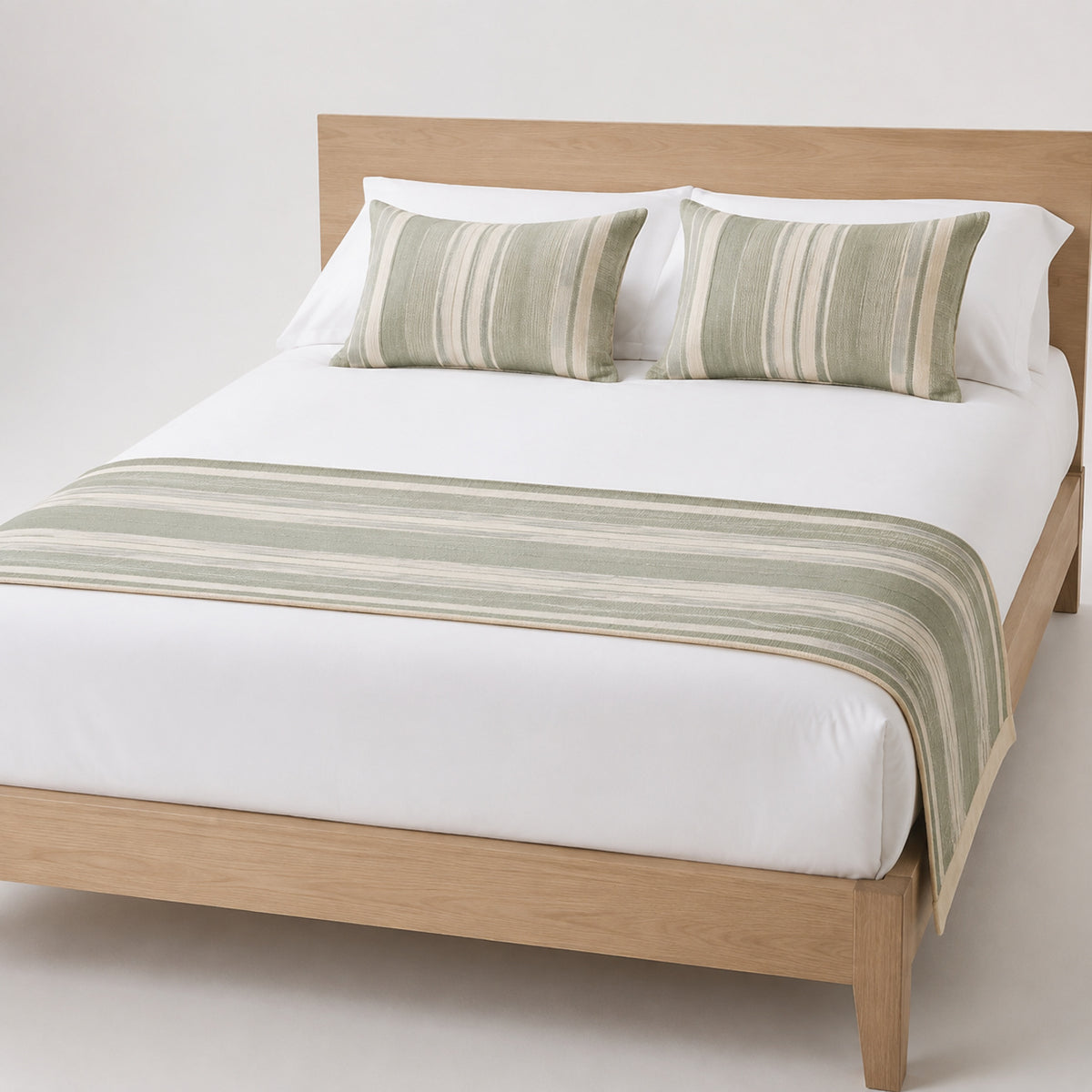 Sage green striped bed runner styled on white bedding for wholesale resort, hotel and private-label bedroom sourcing