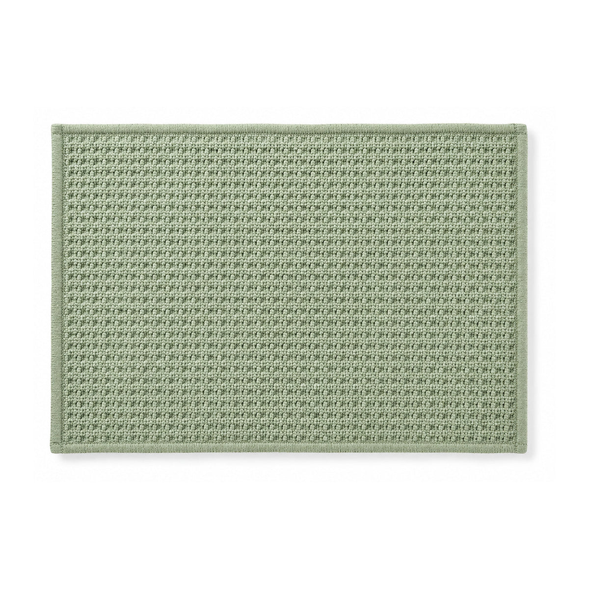 Sage green minimalist woven bath mat on white background