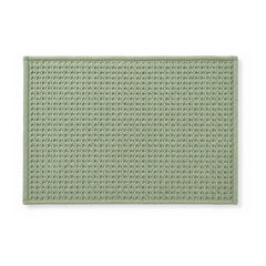 Sage green minimalist woven bath mat on white background