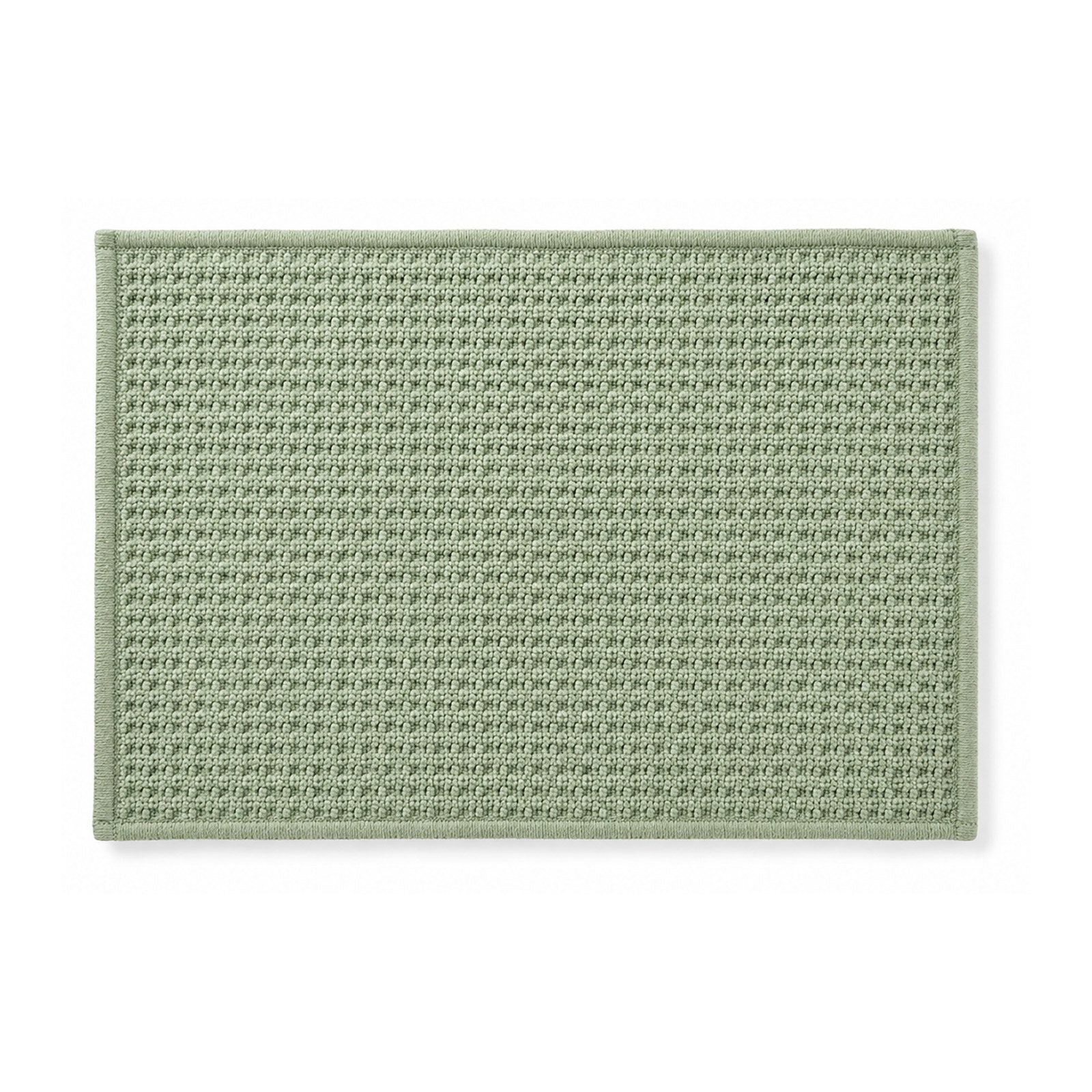 Sage green minimalist woven bath mat on white background