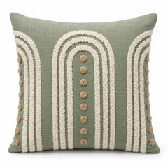 Sage green decorative cushion with ivory arch tufting and textured dot accents