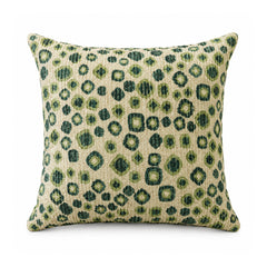 Primeval sage and olive green cushion cover with animal-inspired leopard spots on a cream ground