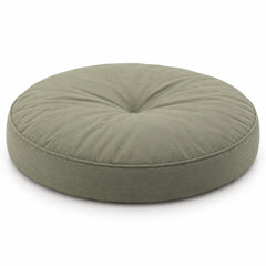 Sage green round floor cushion with central tufting on white background
