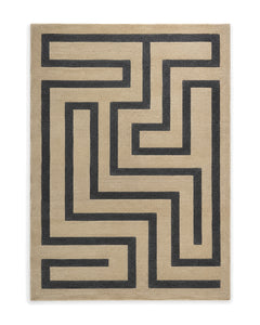Sand and charcoal cut-pile area rug with a bold angular maze pattern on a white background.