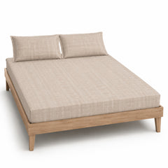 Sand tonal woven-line bed sheet set with matching pillowcases on a wooden bed