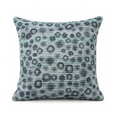 Primeval slate blue and charcoal cushion featuring scattered dark leopard-inspired spots over a faded blue background