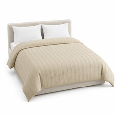 Primeval soft beige tonal raised stripe duvet cover displayed on a styled bed against a clean white studio background