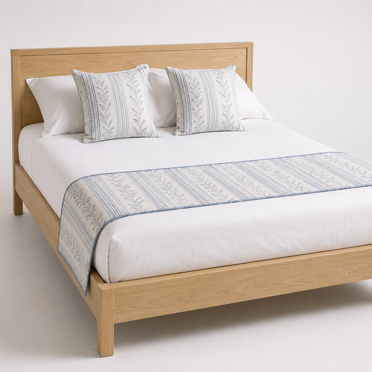 Soft grey tailored stripe bed runner styled on white bedding for wholesale hotel, hospitality and private-label bedroom sourcing