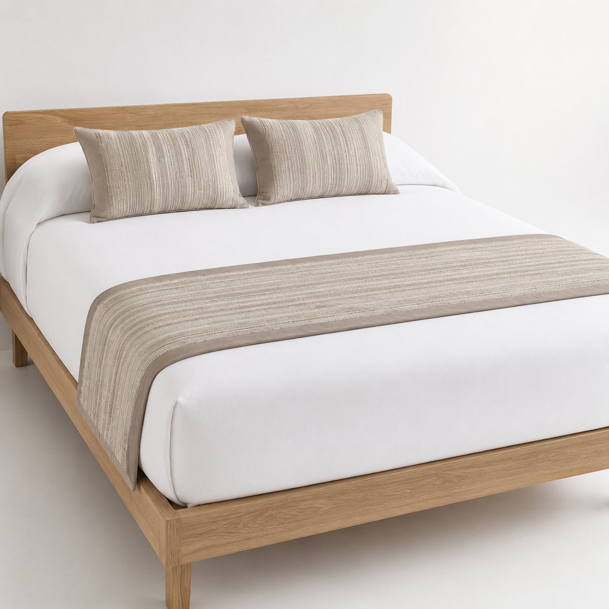 Taupe horizontal-stripe bed runner styled across white bedding for wholesale hotel and private-label bedroom collections