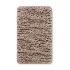 Taupe plush shag bath mat on white background