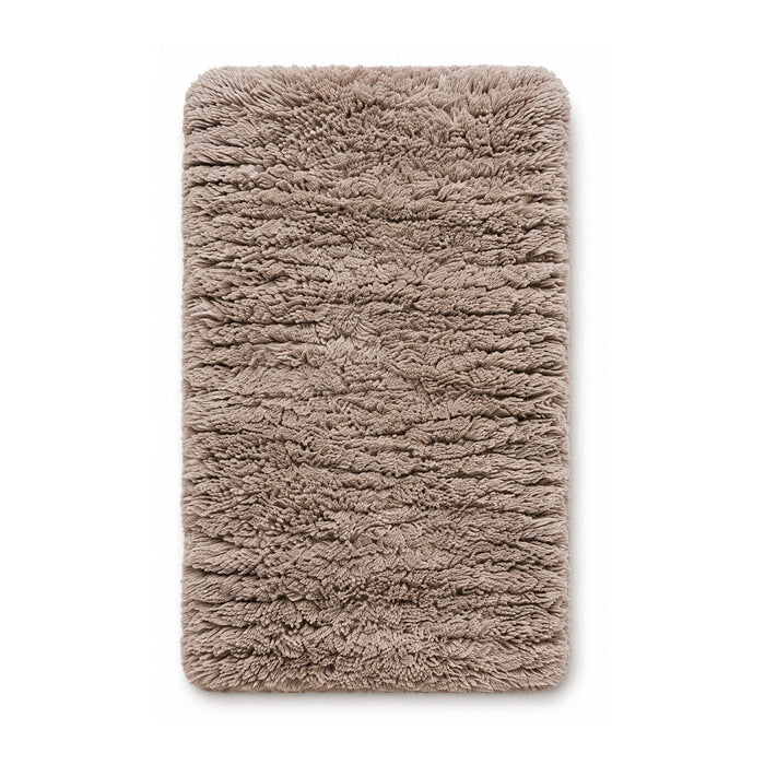 Taupe plush shag bath mat on white background