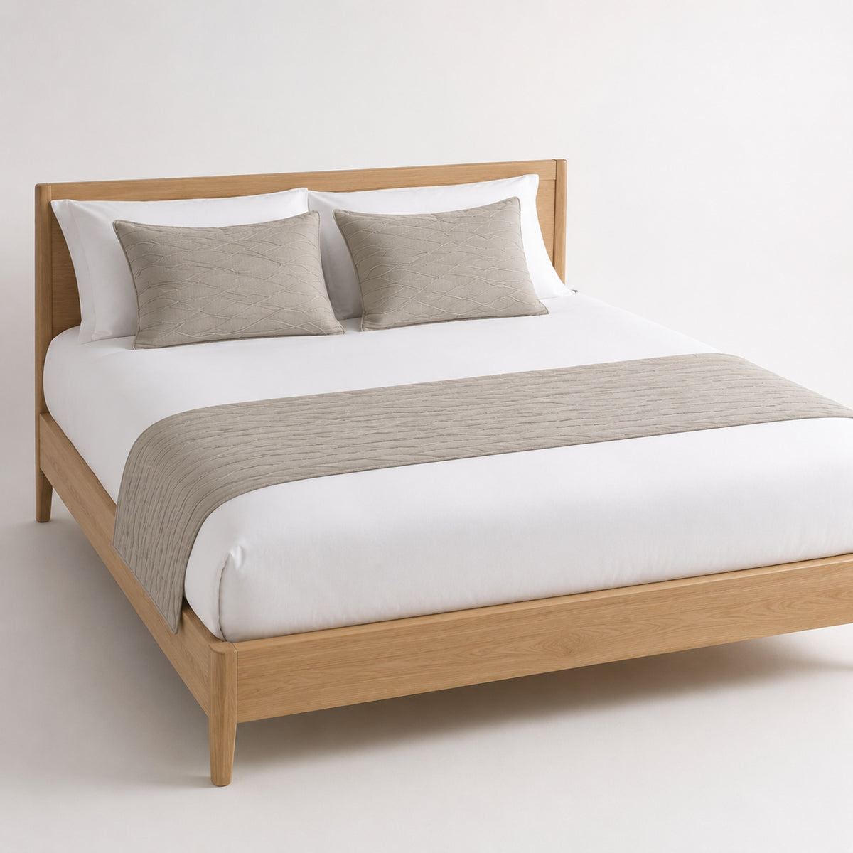 Taupe solid textured bed runner styled on white bedding for wholesale hotel, hospitality and private-label bedroom sourcing