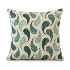 Primeval decorative cushion in teal and sage green with flowing S-shaped abstract waves on a warm ivory ground
