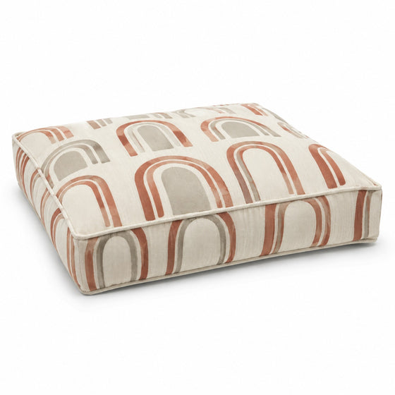 Ivory square floor cushion with terracotta and taupe arch print on white background