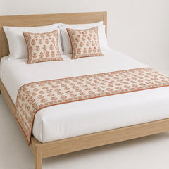 Terracotta diamond block-print-inspired bed runner styled on white bedding for wholesale artisan, resort and private-label bedroom sourcing