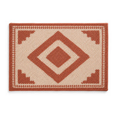 Terracotta and ivory geometric diamond bath mat on white background