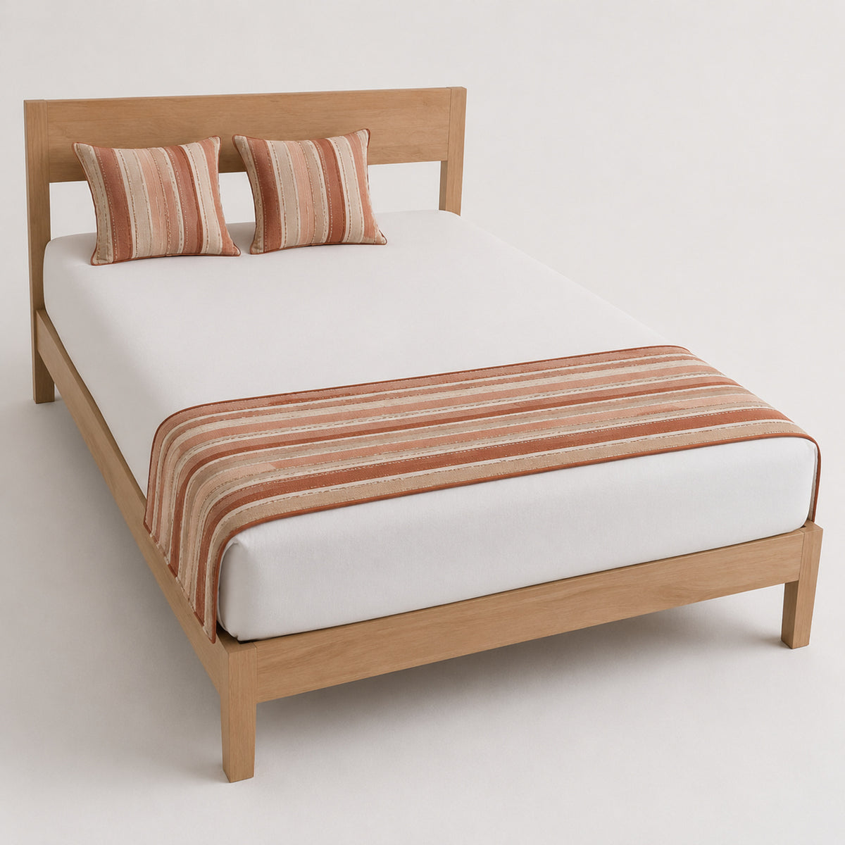 Terracotta rust striped bed runner styled on white bedding for wholesale hospitality, resort and private-label collections