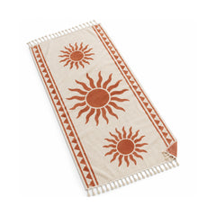 Ivory fringed beach towel with terracotta sun motifs and border pattern.