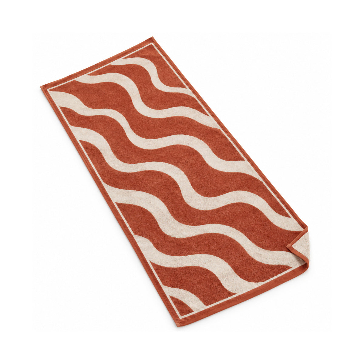 Terracotta beach towel with bold cream wavy stripes on a white background.