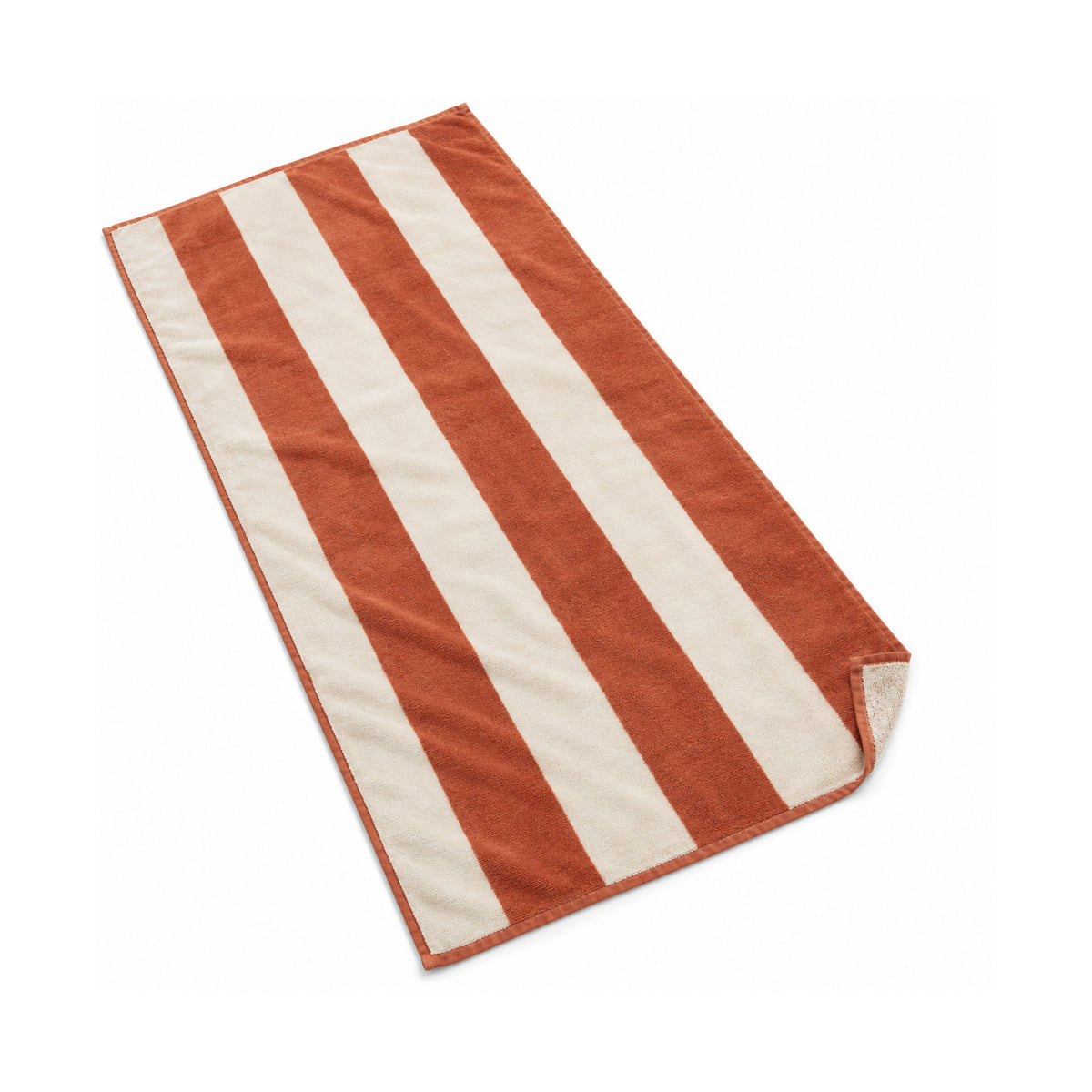 Terracotta and white wide striped fringed beach towel on a white background.