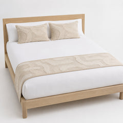 Warm beige abstract-line bed runner styled on white bedding for wholesale modern hotel and private-label bedroom sourcing