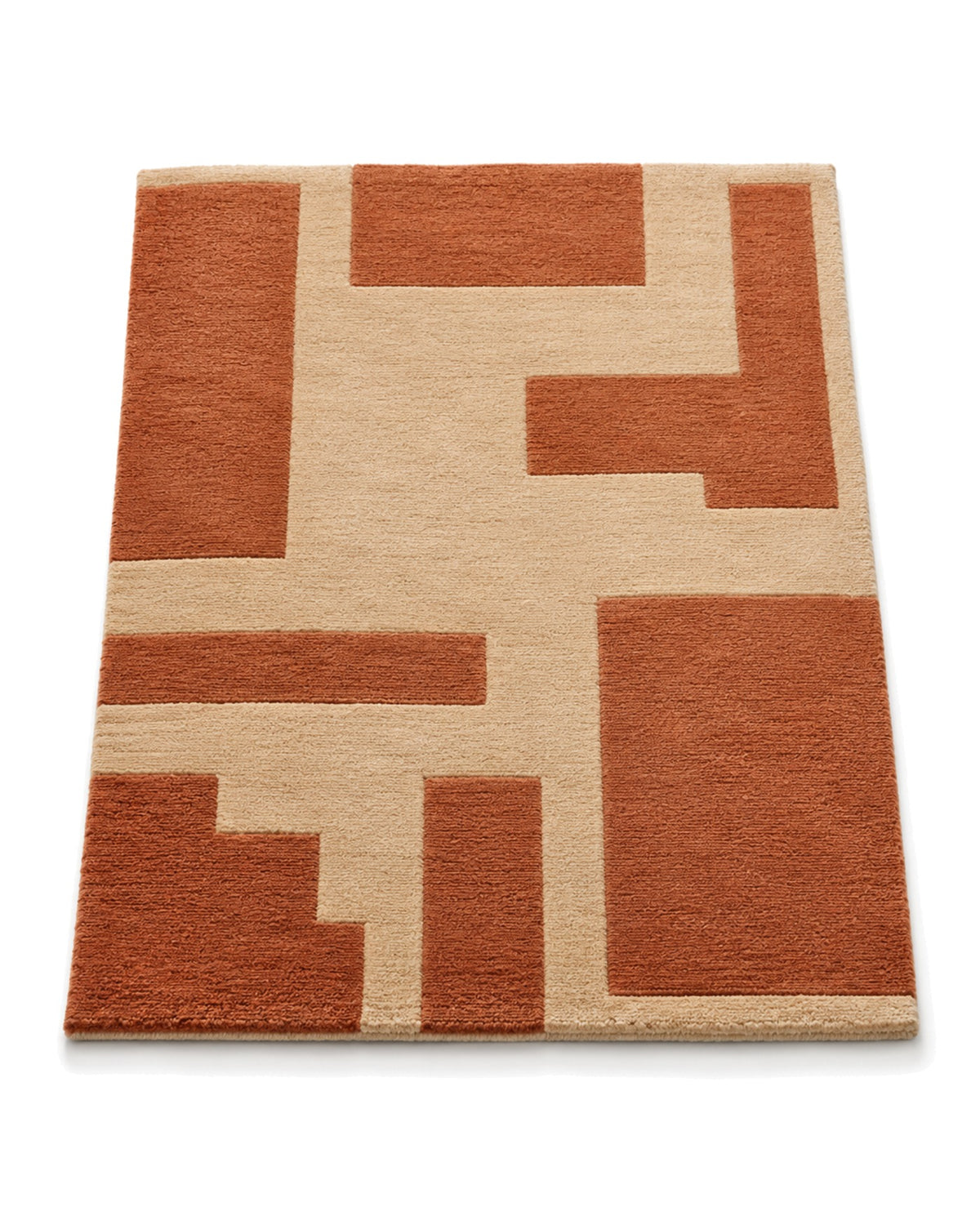 Warm beige and terracotta hand-tufted area rug with bold abstract geometric blocks on a white background.