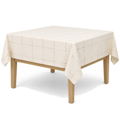Primeval warm cream taupe windowpane tablecloth displayed on a square dining table