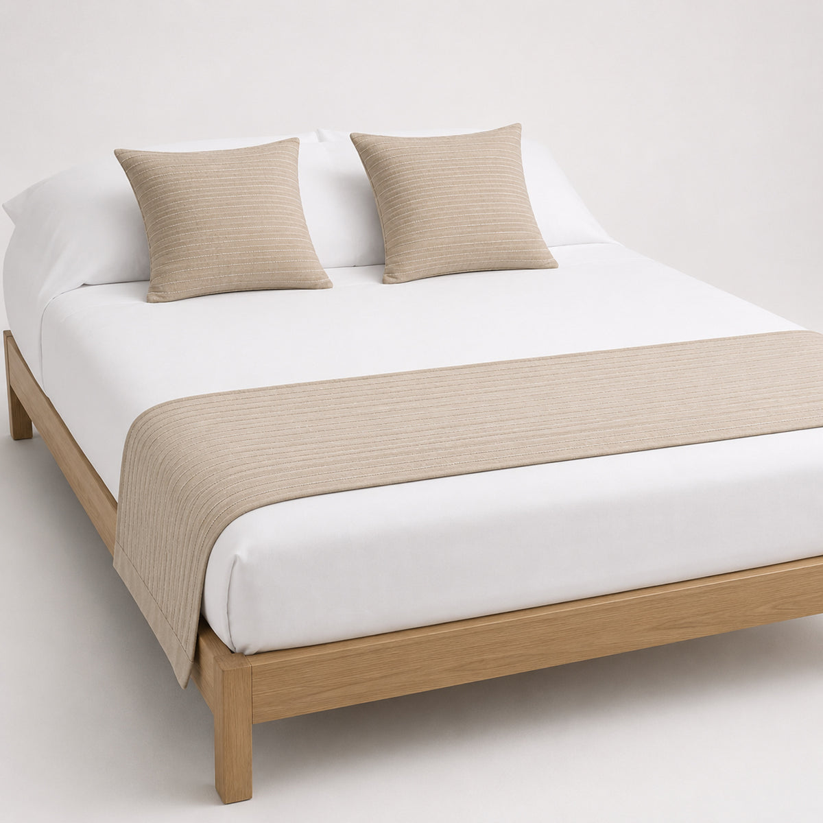 Warm tan textured bed runner styled across a white bed for wholesale hospitality, retail and private-label bedding sourcing