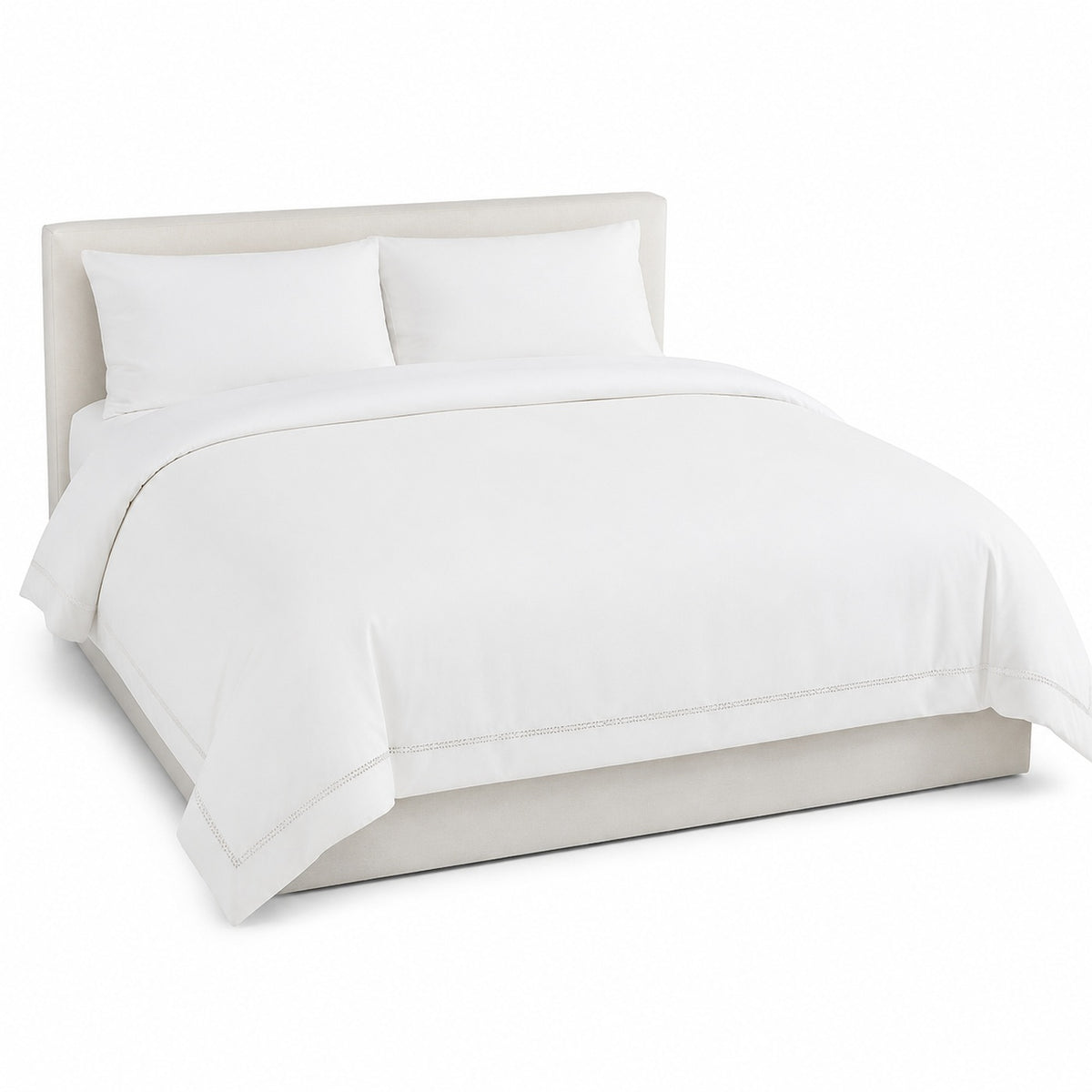 Primeval warm white decorative border duvet cover displayed on a styled bed against a clean white studio background