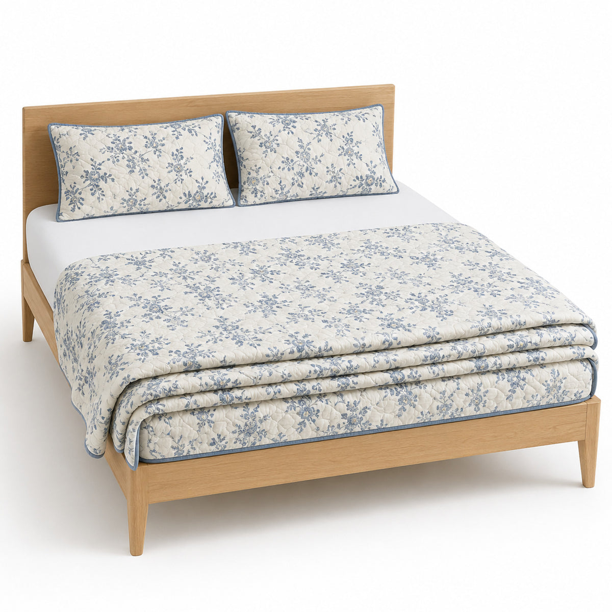 White and dusty blue floral trail cotton quilt, folded with matching pillows for wholesale bedding sourcing